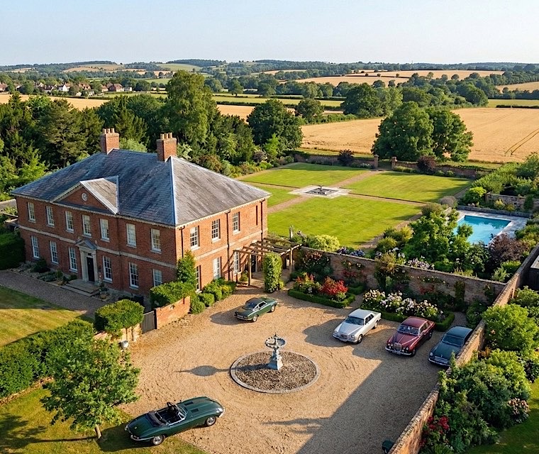 Aerial drone photography of Georgian manor house with classic cars for property listing